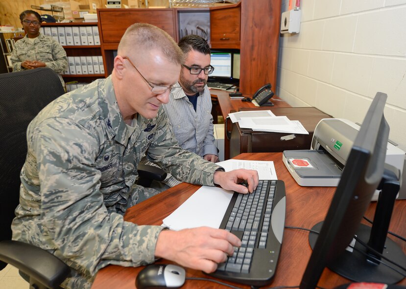 Col. Michael Grismer, 436th Airlift Wing commander, enters information for a new telephone connection into the computer during a visit to the 436th Communications Squadron to learn about computer and telephone upgrades Sept. 30, 2015, at Dover Air Force Base, Del. Grismer was taken through the detailed process by Zane Tuxward, an Air Force contractor; during Grismer???s visit to the work center he learned about the 436 CS???s mission and recognized key individuals for their contributions. (U.S. Air Force photo/Greg L. Davis)