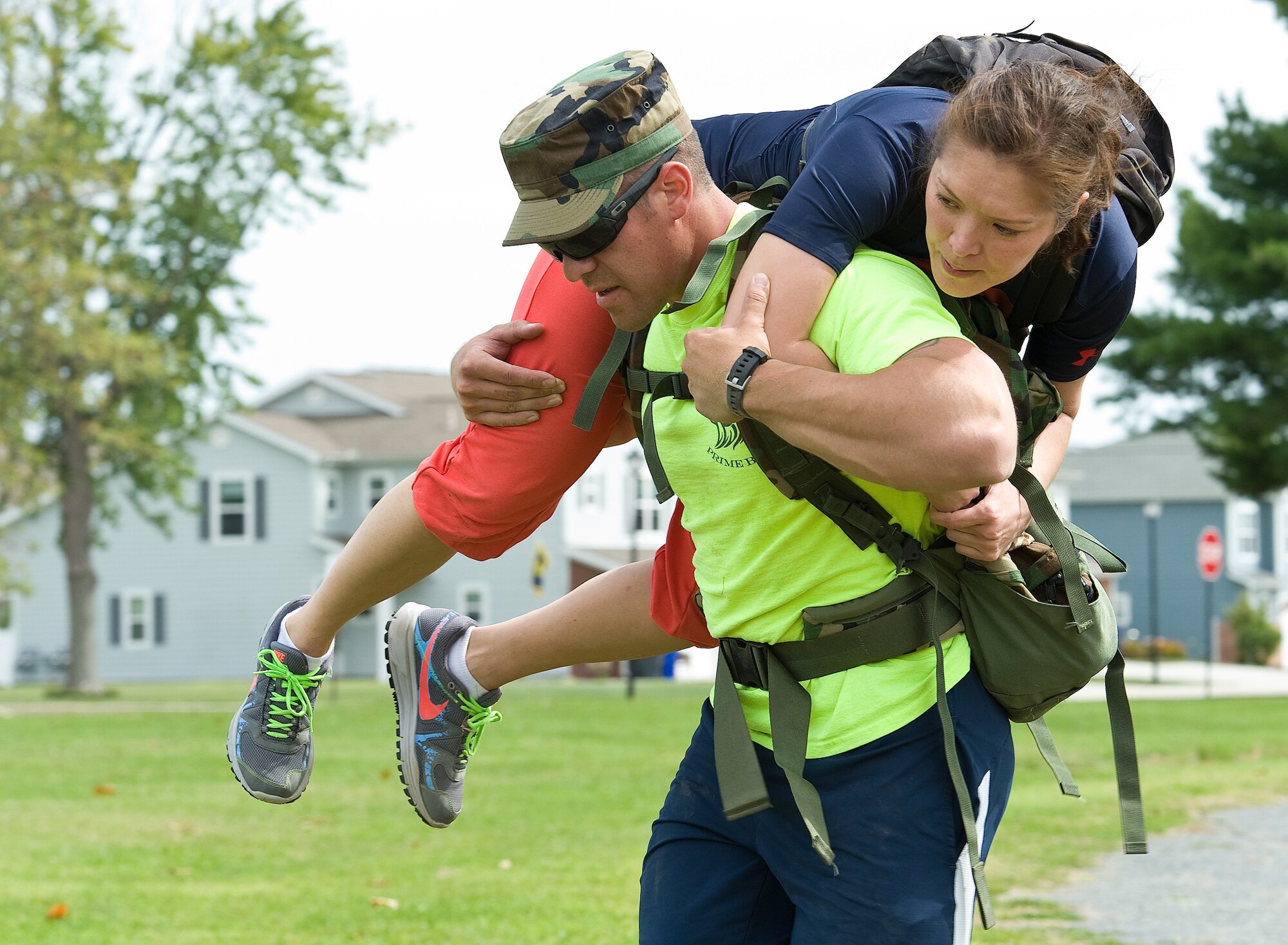 First Lt. Samuel Clark, 436th Civil Engineer Squadron readiness and emergency management deputy flight commander, fireman carries Staff Sgt. Aisuluu Alford, Armed Forces Medical Examiner System laboratory technician, during the GORUCK Light team cohesion challenge Sept. 25, 2015, on Dover Air Force Base, Del. During this particular challenge, all 31 Team Dover members took turns being carried or carrying others to a simulated extraction point. (U.S. Air Force photo/Roland Balik)