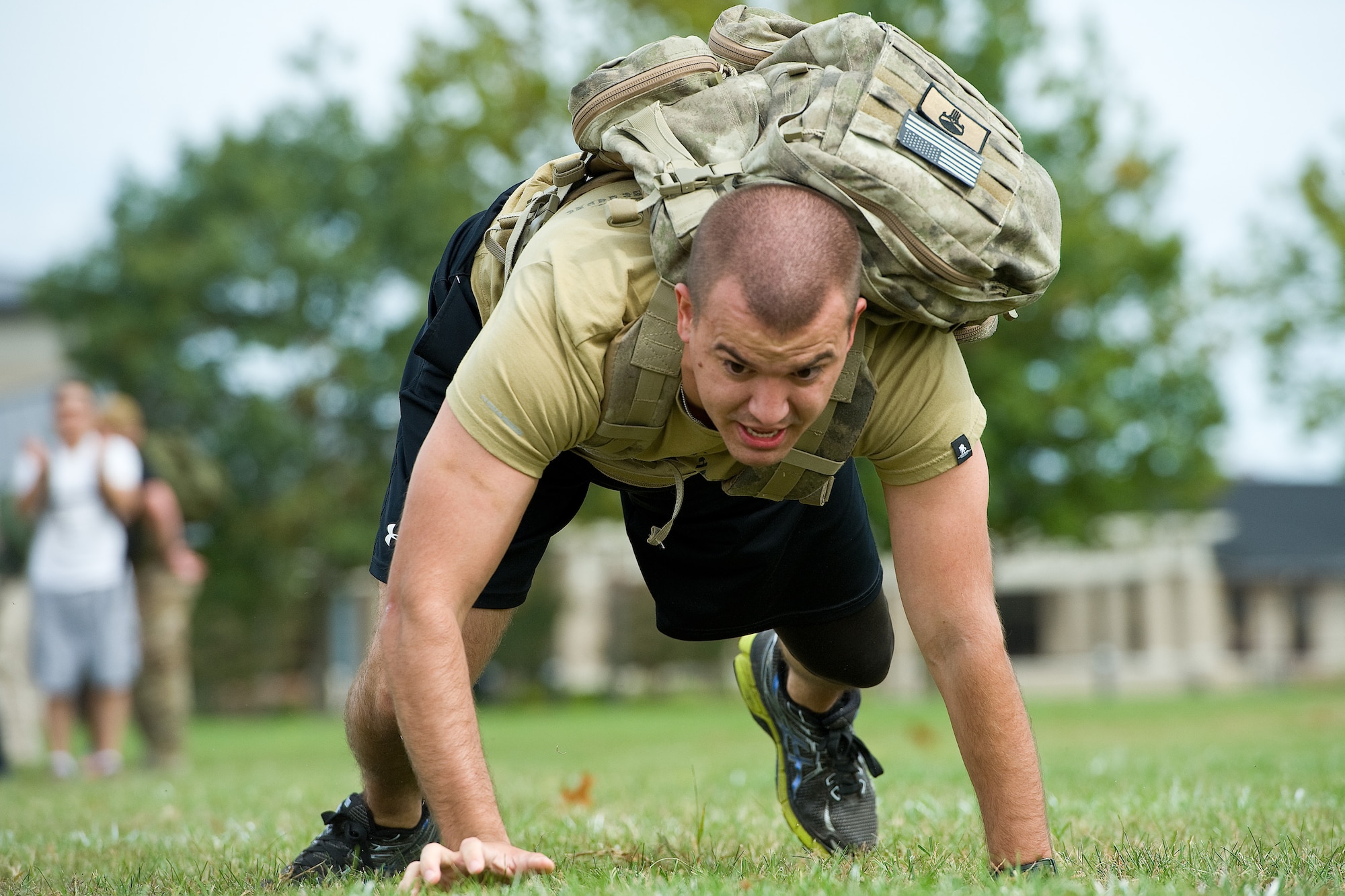 Senior Airman William Johnson, 436th Airlift Wing public affairs photojournalist, bear crawls during the GORUCK Light team cohesion challenge Sept. 25, 2015, on Dover Air Force Base, Del. Johnson, participating in his second GORUCK Light, was one of 31 participants that completed numerous physical challenges led by a qualified GORUCK Light cadre. (U.S. Air Force photo/Roland Balik)