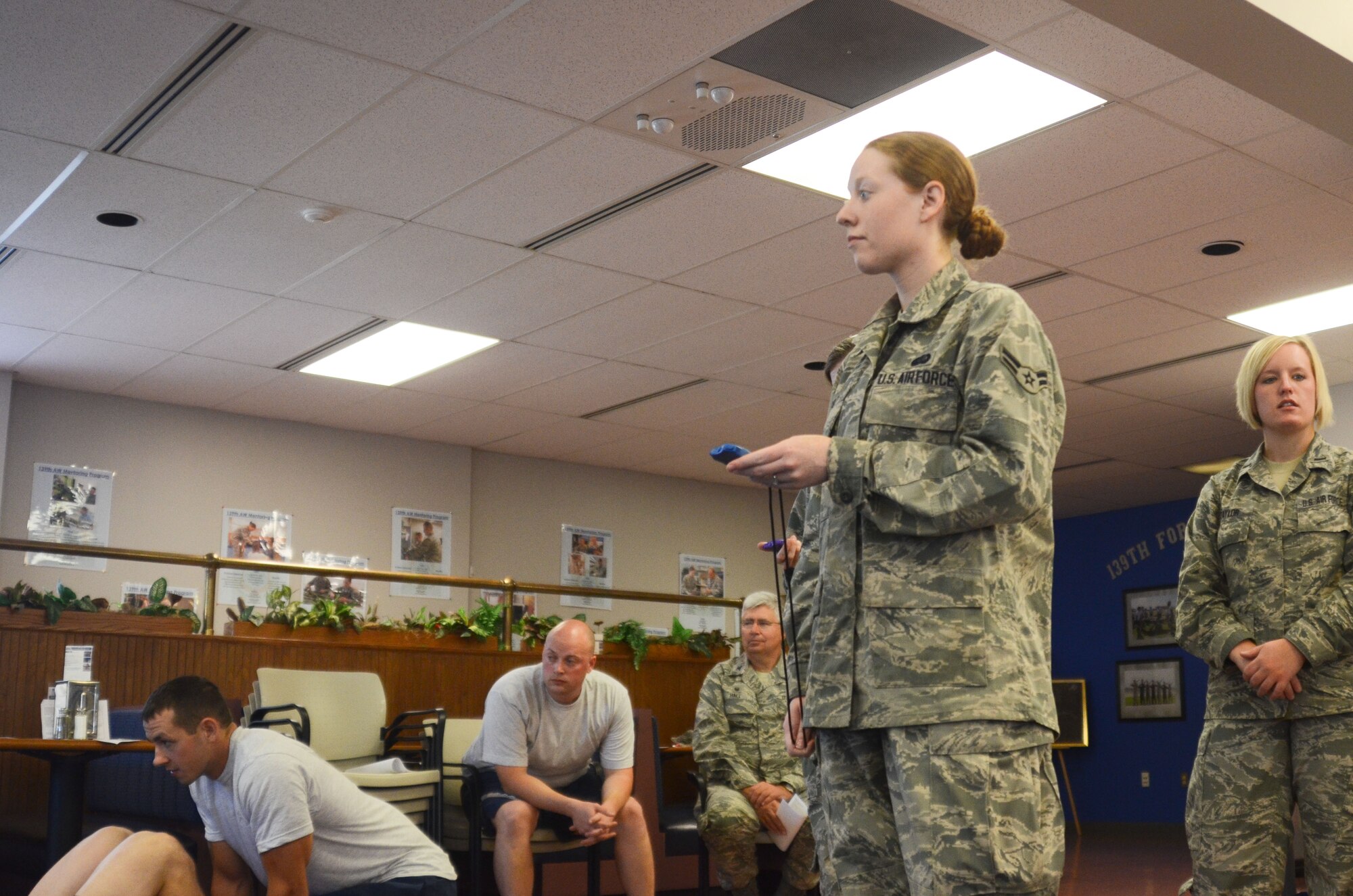 U.S. Air Force Airman 1st Class Erin Self, a services specialist assigned to the 139th Services Flight, keeps track of the time limit while Airmen complete their physical training exam Sept. 20, 2015 at Rosecrans Air National Guard Base, Mo. (U.S. Air National Guard photo by Tech. Sgt. Theo Ramsey/Released)