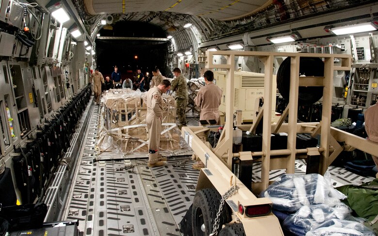COLORADO SPRINGS, Colo. – Airmen from the 21st Logistics Readiness Squadron, 21st Airlift Squadron and Soldiers from the 10th Special Forces Group, 3rd Battalion, load a C-17 Globemaster III from Travis Air Force Base, Calif., at the Arrival/Departure Airlift Control Group, Oct. 1, 2015. Staffed by the 21st LRS air terminal operations team, the A/DACG prepares every deploying and returning unit from Fort Carson and the surrounding military installations. The team is also responsible for the Peterson passenger terminal and scheduling space-available flights for active duty and retired service members. (U.S. Air Force photo by Senior Airman Tiffany DeNault)