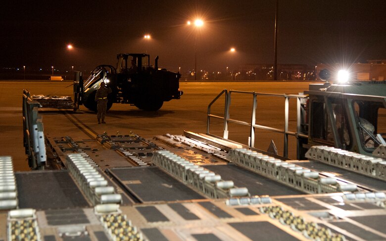 COLORADO SPRINGS, Colo. – Airmen from the 21st Logistics Readiness Squadron air terminal operations, operate loading equipment to load equipment on a C-17 Globemaster III from Travis Air Force Base, Calif., at the Arrival/Departure Airlift Control Group, Oct. 1, 2015. The 21st LRS air terminal team, Airmen from the 21st Airlift Squadron and Soldiers from the 10th Special Forces Group 3rd Battalion load the C-17 upon arrival in preparation for the Airmen and Soldiers’ next destination. (U.S. Air Force photo by Senior Airman Tiffany DeNault)