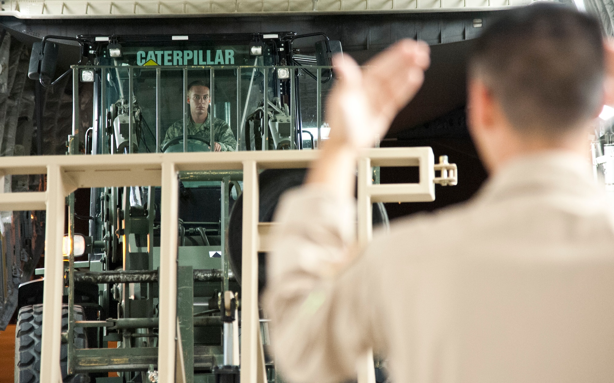 COLORADO SPRINGS, Colo. - Airman 1st Class Chase Rocheleau, 21st Logistics Readiness Squadron air terminal operations, operates a forklift while loading a C-17 Globemaster III, from Travis Air Force Base, Calif., at the Arrival/Departure Airlift Control Group, Oct. 1, 2015. The 21st LRS air terminal team, Airmen from the 21st Airlift Squadron and Soldiers from the 10th Special Forces Group 3rd Battalion load the C-17 upon arrival in preparation for the Airmen and Soldiers’ next destination. (U.S. Air Force photo by Senior Airman Tiffany DeNault)