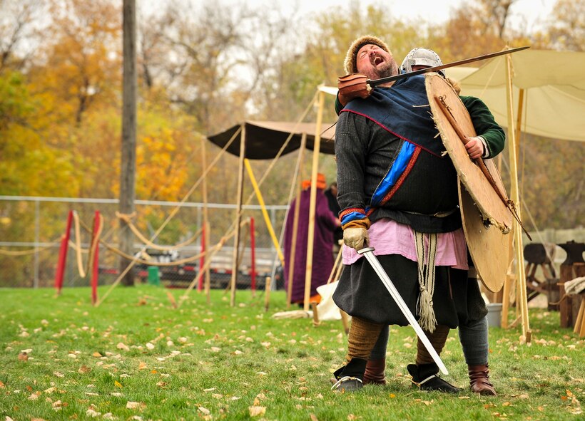 Sam Overland, Viking reenactor, pretends to be sleigh by another actor during Norsk Høstfest Military Appreciation Day in Minot N.D., Oct. 3, 2015. Overland and his fellow Vikings educated the crowd on Nordic battle customs and weaponry. (U.S. Air Force photo/Senior Airman Stephanie Morris)