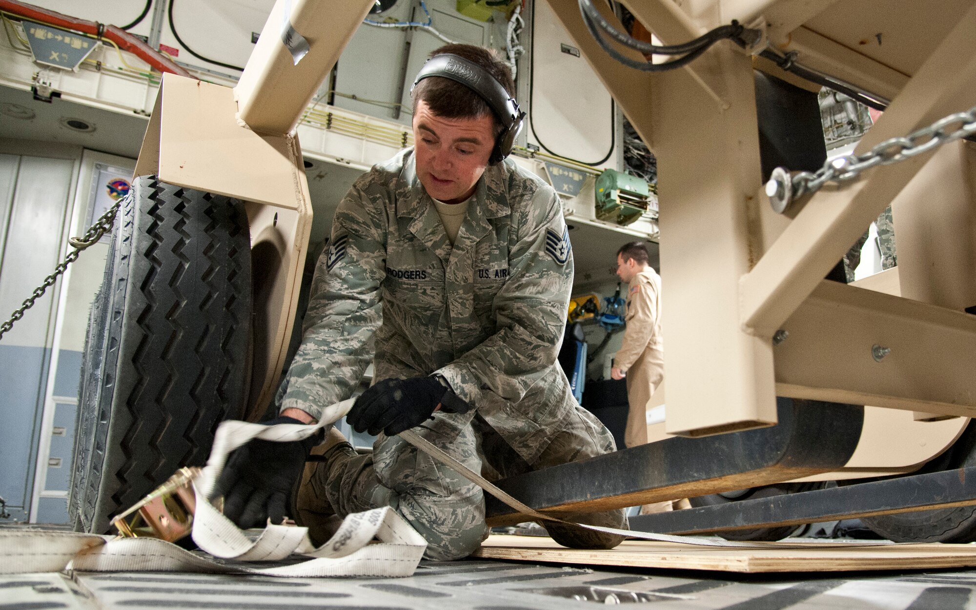COLORADO SPRINGS, Colo. – Staff Sgt. Ryan Rodgers, 21st Logistics Readiness Squadron air terminal operations, ratchets a piece of equipment down in a C-17 Globemaster III, from Travis Air Force Base, Calif., at the Arrival/Departure Airlift Control Group, Oct. 1, 2015. Once the C-17 landed, it was taxied to the A/DACG where Rodgers, his team, Airmen from the 21st Airlift Squadron and Soldiers from 10th Special Force Group, 3rd Battalion unloaded the cargo. The 21st LRS air terminal team load and unload every deploying and returning Army and Air Force unit from Fort Carson and the surrounding military installation in the Pikes Peak region. (U.S. Air Force photo by Senior Airman Tiffany DeNault)