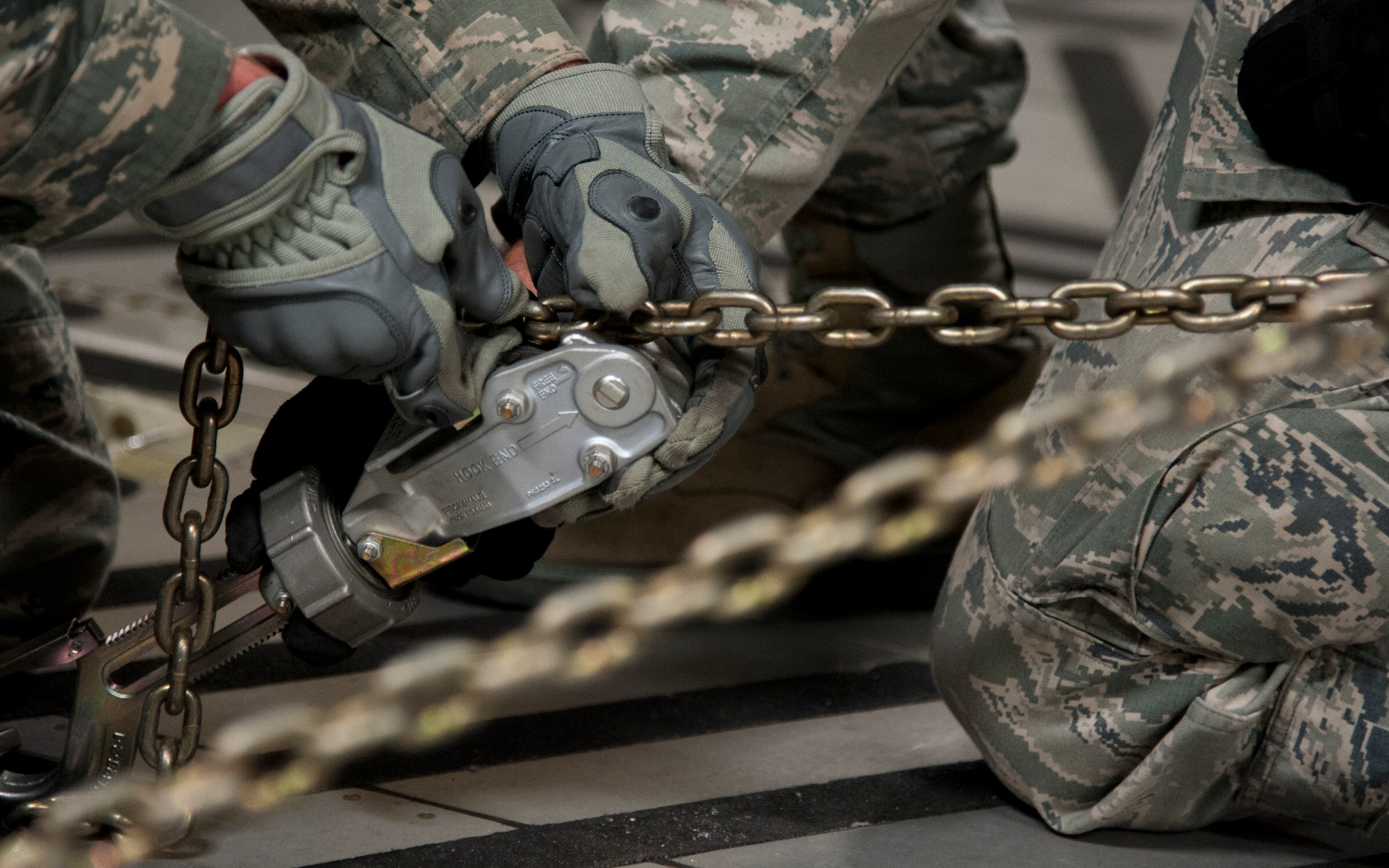 COLORADO SPRINGS, Colo. – Staff Sgt. Ryan Rodgers and Senior Airman Dan Hurlburt, 21st Logistics Readiness Squadron air terminal operations, chains down a piece of equipment while loading a C-17 Globemaster III, from Travis Air Force Base, Calif., at the Arrival/Departure Airlift Control Group, Oct. 1, 2015. Staffed by the 21st LRS, the A/DACG prepares every deploying and returning unit from Fort Carson and the surrounding military installations in the Pikes Peak region. (U.S. Air Force photo by Senior Airman Tiffany DeNault)