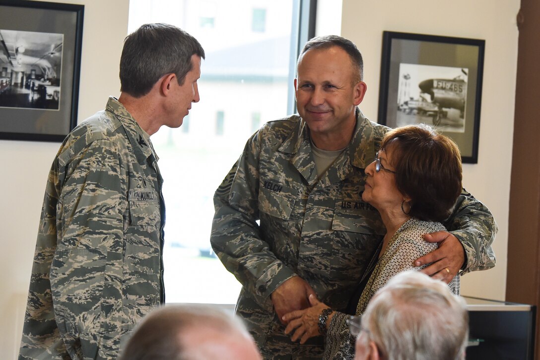 From left to right, U.S. Air Force Col. Thomas Kunkel, 23d Wing commander, Chief Master Sgt. David Kelch, 23d WG command chief, and Ruth Treadwell, 347th Rescue Group secretary, exchange farewells during Ruth’s retirement ceremony Oct. 1, 2015, at Moody Air Force Base, Ga. Ruth retired after serving 32 years as an administrative civilian employee. (U.S. Air Force photo by Senior Airman Ceaira Tinsley/Released)