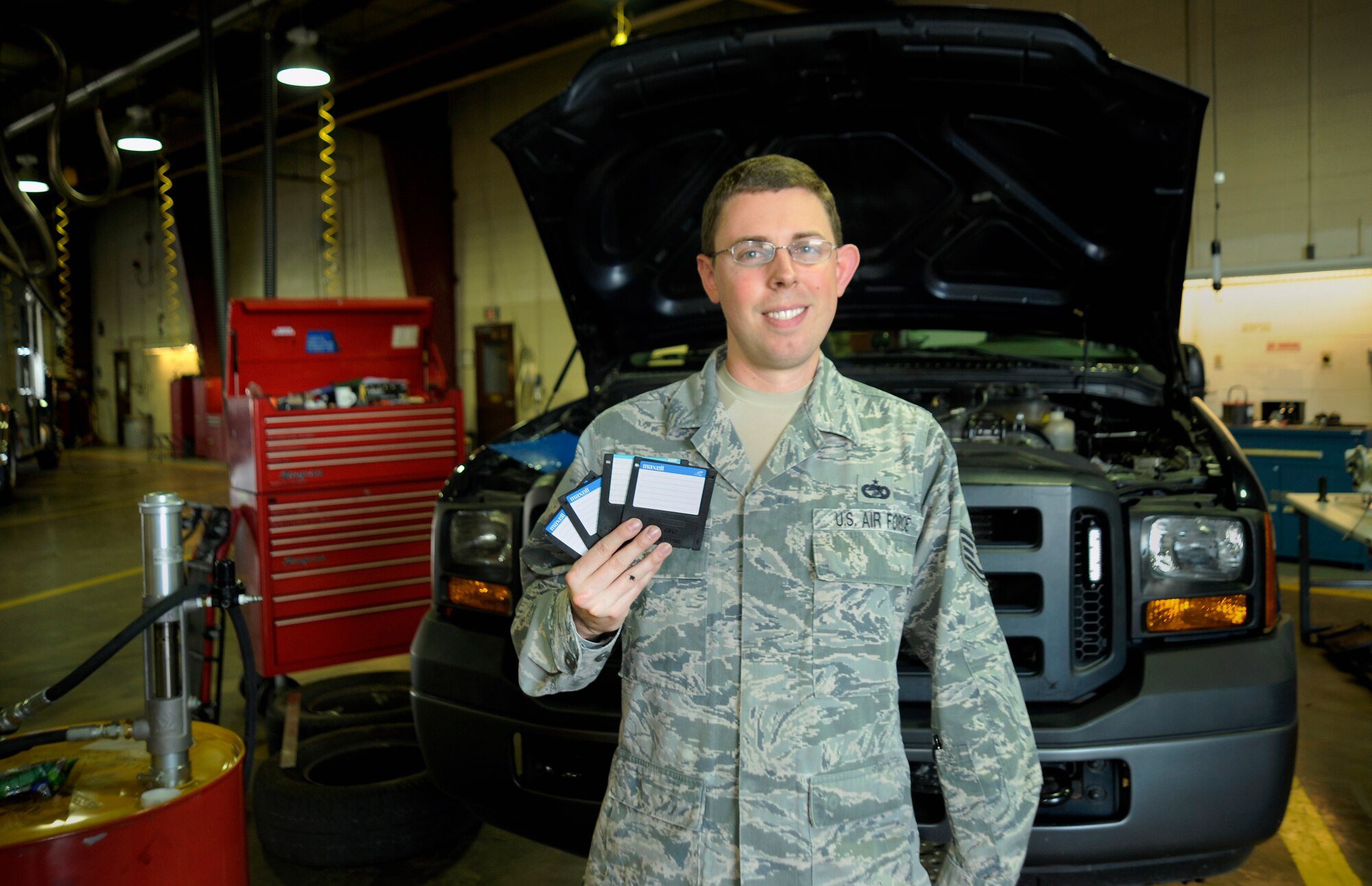 Oregon Air National Guard Tech. Sgt. Andrew Saunders, a Vehicle Management and Analysis specialist for the 142nd Fighter Wing, shows off  a set of floppy disks used to run the On-Line Vehicle Interactive Management System (OLVIMS), a legacy system that is being phased out of use due in part to Saunders’ efforts., Oct. 3, 2015, Portland Air National Guard Base, Ore. (U.S. Air National Guard photo by Staff Sgt. Brandon Boyd, 142nd Fighter Wing Public Affairs/Released)