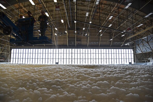 The 92nd Civil Engineer Squadron, maintainers, emergency responders and local contractors complete the foam suppression test in hangar one Oct. 1, 2015, at Fairchild Air Force Base, Wash. The test ran for approximately two-and-a-half minutes creating over six feet of foam which covered the entire hangar floor, which is 68,000 square feet. (U.S. Air Force photo/Airman 1st Class Mackenzie Richardson) 