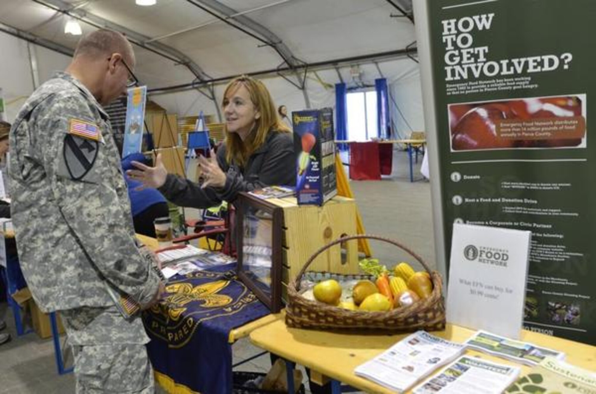 Barb Perez with Boy Scouts of America talks with Staff Sgt. Kevin Young during the Combined Federal Campaign kick off Sept. 28. (Northwest Guardian photo/Veronica Sandate Craker)