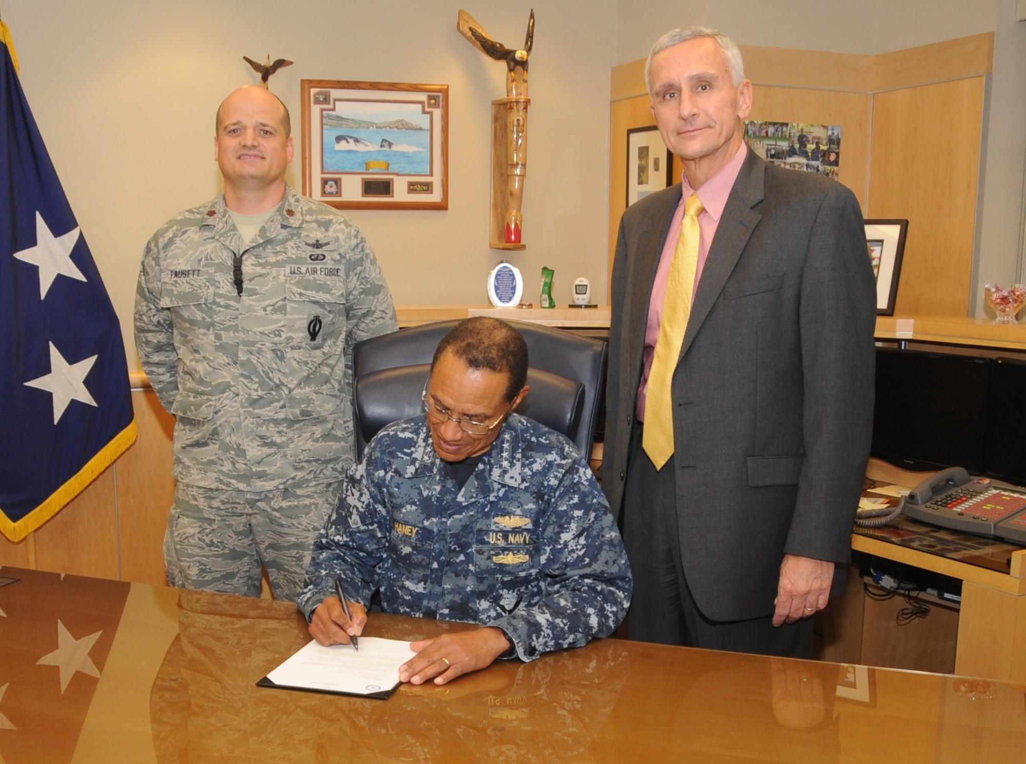 U.S. Navy Adm. Cecil D. Haney (center), U.S. Strategic Command commander, signs the 2015 USSTRATCOM Combined Federal Campaign kickoff letter at Offutt Air Force Base, Neb., Sept. 29, 2015. Prior to signing the document, Haney met with Paul Ross (right), the 2015 CFC chairman, and U.S. Air Force Maj. Trent Fausett, USSTRATCOM’s 2015 CFC manager, to discuss this year’s campaign, which officially begins Oct. 6 and runs until Dec. 15. CFC is the world’s largest workplace giving program and partners with nonprofit, charitable organizations around the world, benefiting a wide range of causes. (USSTRATCOM photo by Steve Cunningham/Released)
