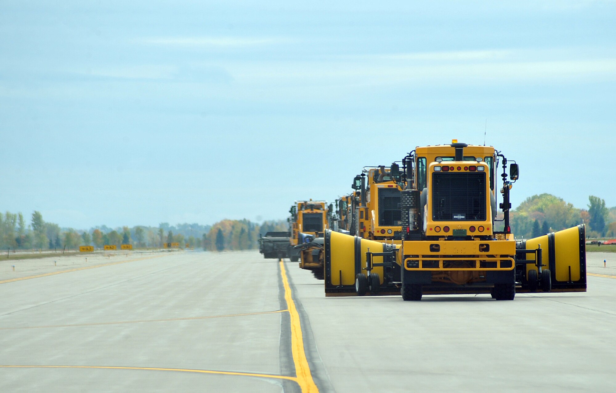 Snow removal equipment being operated by base commanders heads back to the starting point as the annual Snow Parade comes to an end Oct. 5, 2015, on Grand Forks Air Force Base, North Dakota. There were 12 pieces of snow removal equipment in the parade this year. (U.S. Air Force photo by Airman 1st Class Bonnie Grantham/released)