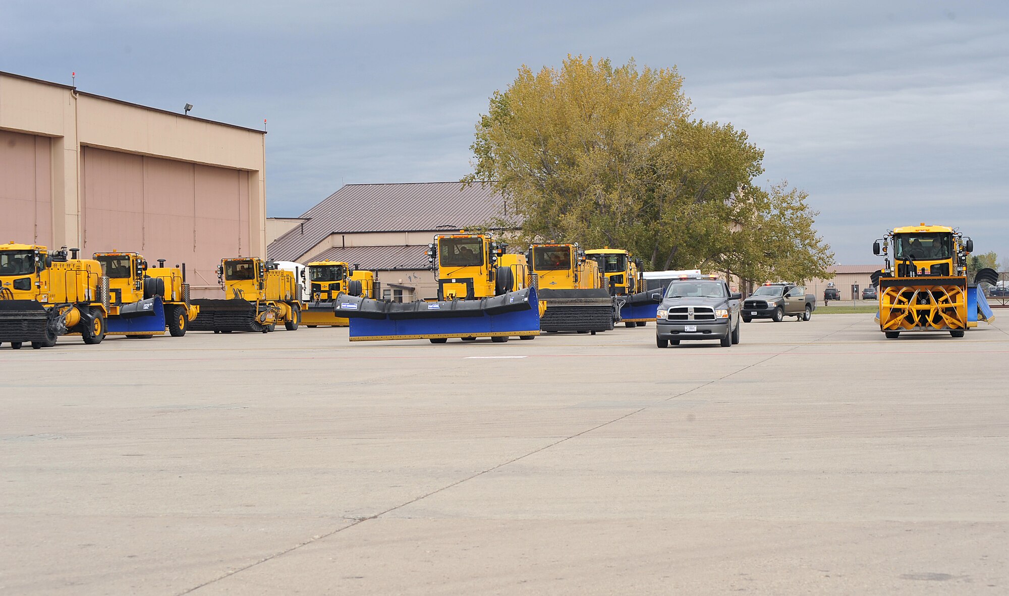 Snow removal equipment is lined up in preparation for the annual Snow Parade on the flight line Oct. 5, 2015 on Grand Forks AFB, North Dakota. There were 12 pieces of snow removal equipment in the parade this year. (U.S. Air Force photo by Airman 1st Class Bonnie Grantham/released)