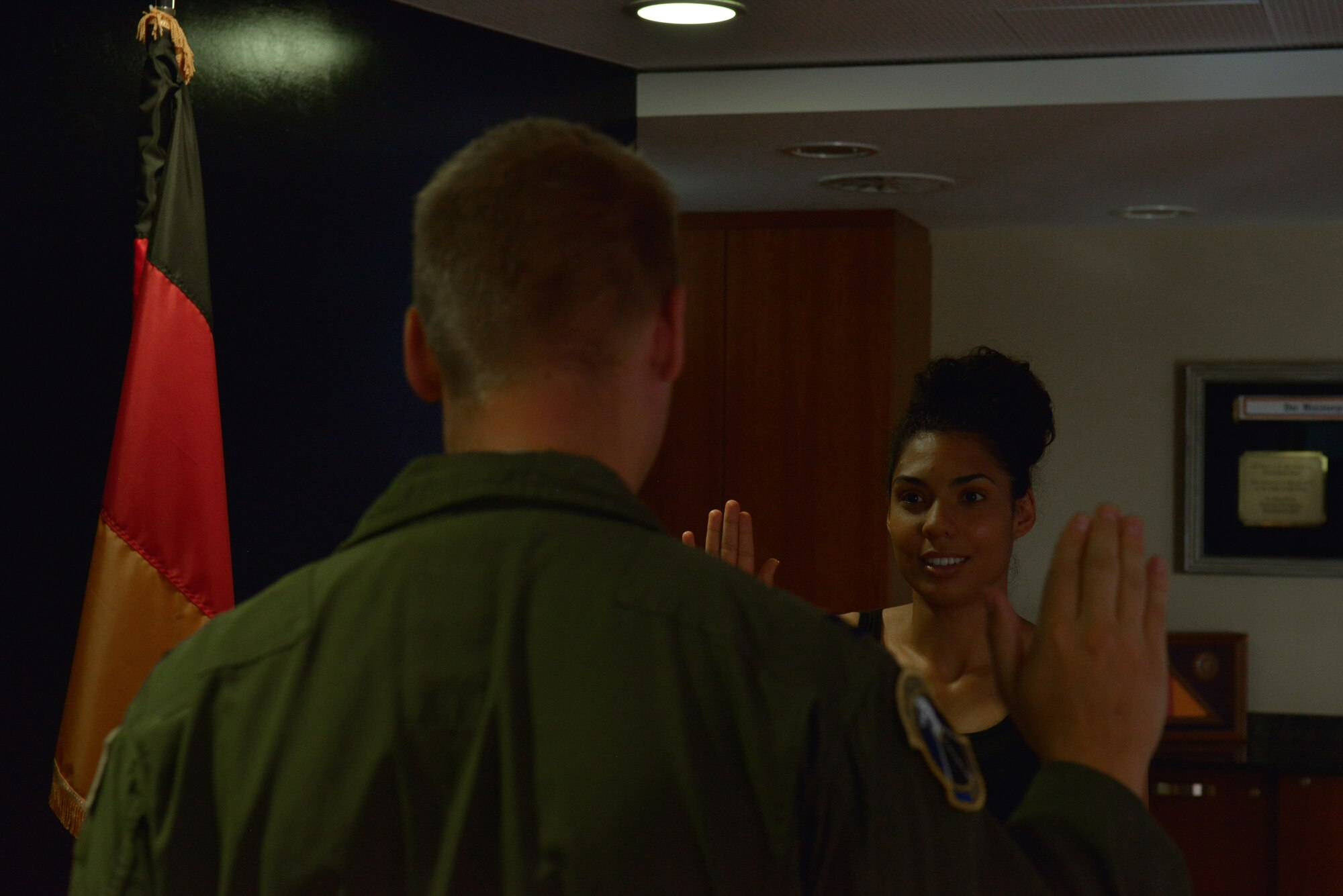 Jazmine Michaels takes the Oath of Enlistment to become a member of the U.S. Air Force Delayed Entry Program Aug. 12, 2015, at Ramstein Air Base, Germany. Michaels is a recruit of Tech. Sgt. Mubarak Rashid, 319th Recruiting Squadron Enlisted Accessions Recruiter. (U.S. Air Force photo/Airman 1st Class Lane T. Plummer)