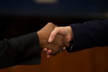 Spangdahlem community members greet each other before discussing job opportunities during a job fair at Club Eifel on Spangdahlem Air Base, Germany, Oct. 6, 2015. Job seekers were encouraged to dress appropriately and bring their resumes to hand out to the hiring agencies. (U.S. Air Force photo by Staff Sgt. Christopher Ruano/Released)