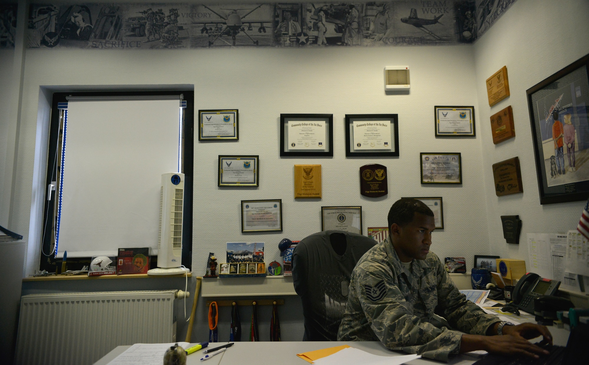 Tech. Sgt. Mubarak Rashid, 319th Recruiting Squadron Enlisted Accessions Recruiter, works at his new office Aug. 12, 2015, at Ramstein Air Base, Germany. Rashid is responsible for inspiring, engaging and recruiting future enlisted Airmen to deliver airpower for the U.S. (U.S. Air Force photo/Airman 1st Class Lane T. Plummer)