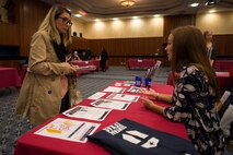 Desiree Herndon, wife of U.S. Air Force Staff Sgt. Dillon Herndon, 52nd Component Maintenance Squadron jet engine intermediate maintenance crew supervisor, talks to a representative of a base educational institution during a job fair at Club Eifel on Spangdahlem Air Base, Germany, Oct. 6, 2015. The job fair was a forum for base agencies to inform the community of job opportunities. (U.S. Air Force photo by Staff Sgt. Christopher Ruano/Released)
