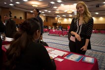 Hannah Dimorier, wife of U.S. Air Force Staff Sgt. Christopher Dimorier, 52nd Component Maintenance Squadron jet engine intermediate maintenance crew supervisor, talks to a representative of a base educational institution during a job fair at Club Eifel on Spangdahlem Air Base, Germany, Oct. 6, 2015. Agencies with job opportunities included food, education and auto services. (U.S. Air Force photo by Staff Sgt. Christopher Ruano/Released)

