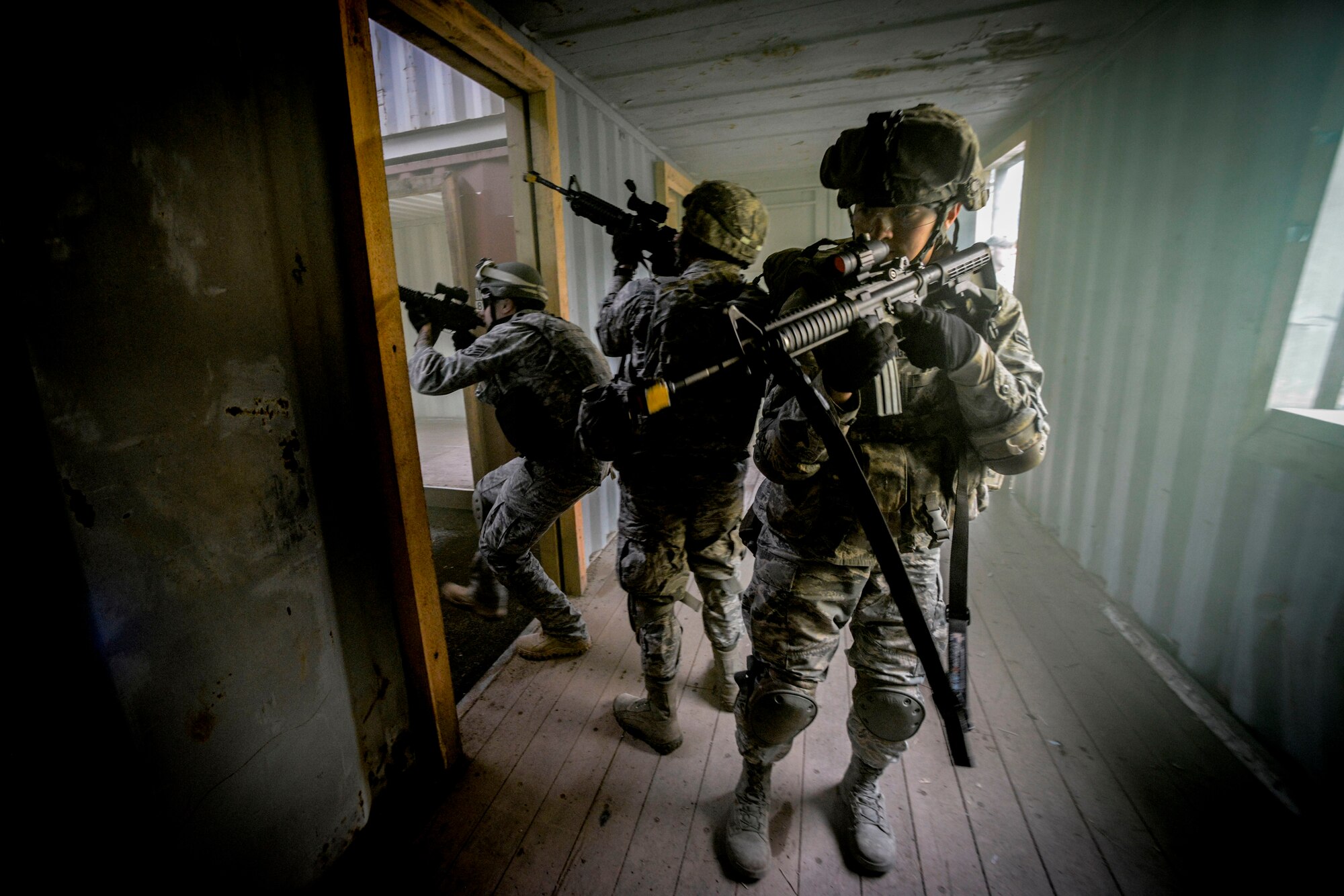 U.S. Air Forces in Europe and Air Forces Africa security forces members invade a building during a Creek Defender field training exercise Sept. 26, 2015, on Baumholder, Germany.  After arriving at their insertion point, security forces members traveled more than 2,100 meters on foot and by vehicle to tactically take hold of a village to establish a base operations center. (U.S. Air Force photo/Senior Airman Nicole Sikorski))
