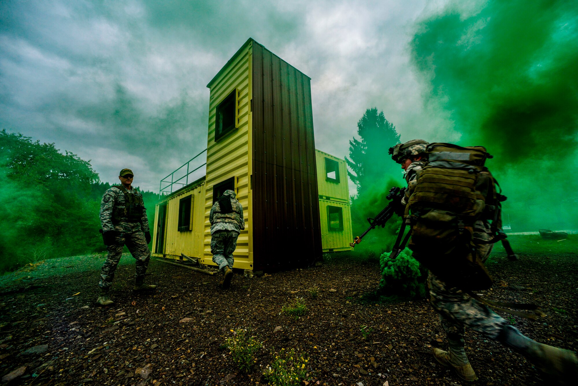 U.S. Air Forces in Europe and Air Forces Africa security forces members secure a village during a Creek Defender field training exercise Sept. 26, 2015, on Baumholder, Germany.  Cadre from the 435th Regional Training Center tested 25 “defenders” on skills they learned throughout the course over the two-day field training exercise. (U.S. Air Force photo/Senior Airman Nicole Sikorski)