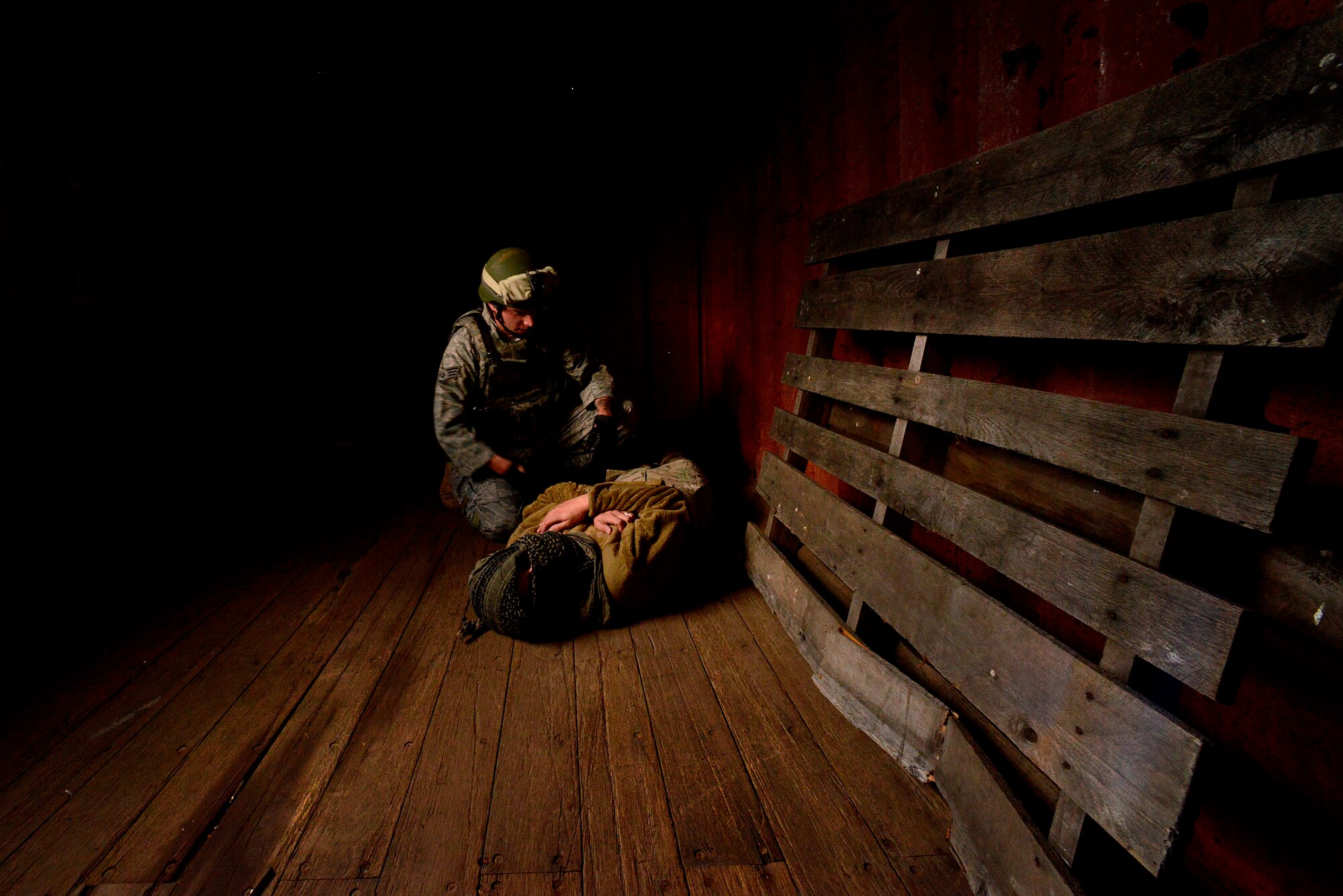 Security forces members simulate an enemy kill during the Creek Defender field training exercise Sept. 26, 2015, on Baumholder, Germany.  After the 21-day Creek Defender course, security forces members were placed in a training environment, where they were tested on dismounted and mounted patrols, land navigation, range estimation, weapons firing and tactical firing under stress. (U.S. Air Force photo/Senior Airman Nicole Sikorski)