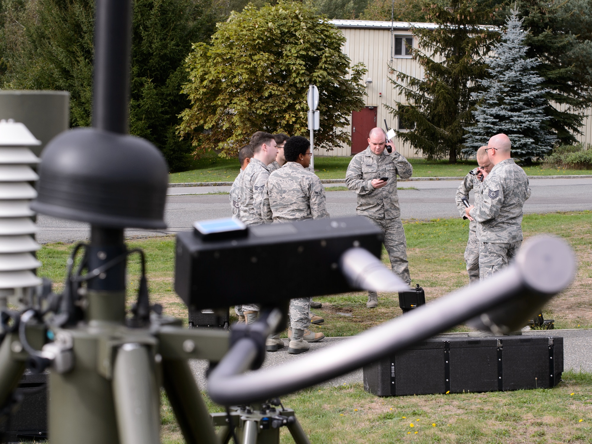 Airmen from the 7th Weather Squadron learn about the satellite phone that allows them to communicate data anywhere in the world during a training exercise Sept. 16, 2015, at Grafenwohr Training Area, Germany. The instructors of the 7th WS used a variety of tools including briefing and hands-on lessons to develop 30 battlefield weather airmen during the annual Cadre Focus training exercise. The 7th WS revamped Cadre Focus to concentrate on basic field training skills and forecasting in Eastern Europe. The squadron is the only one embedded alongside Army units providing weather intelligence throughout the European and African areas of operation. (U.S. Air Force photo/Staff Sgt. Armando A. Schwier-Morales)