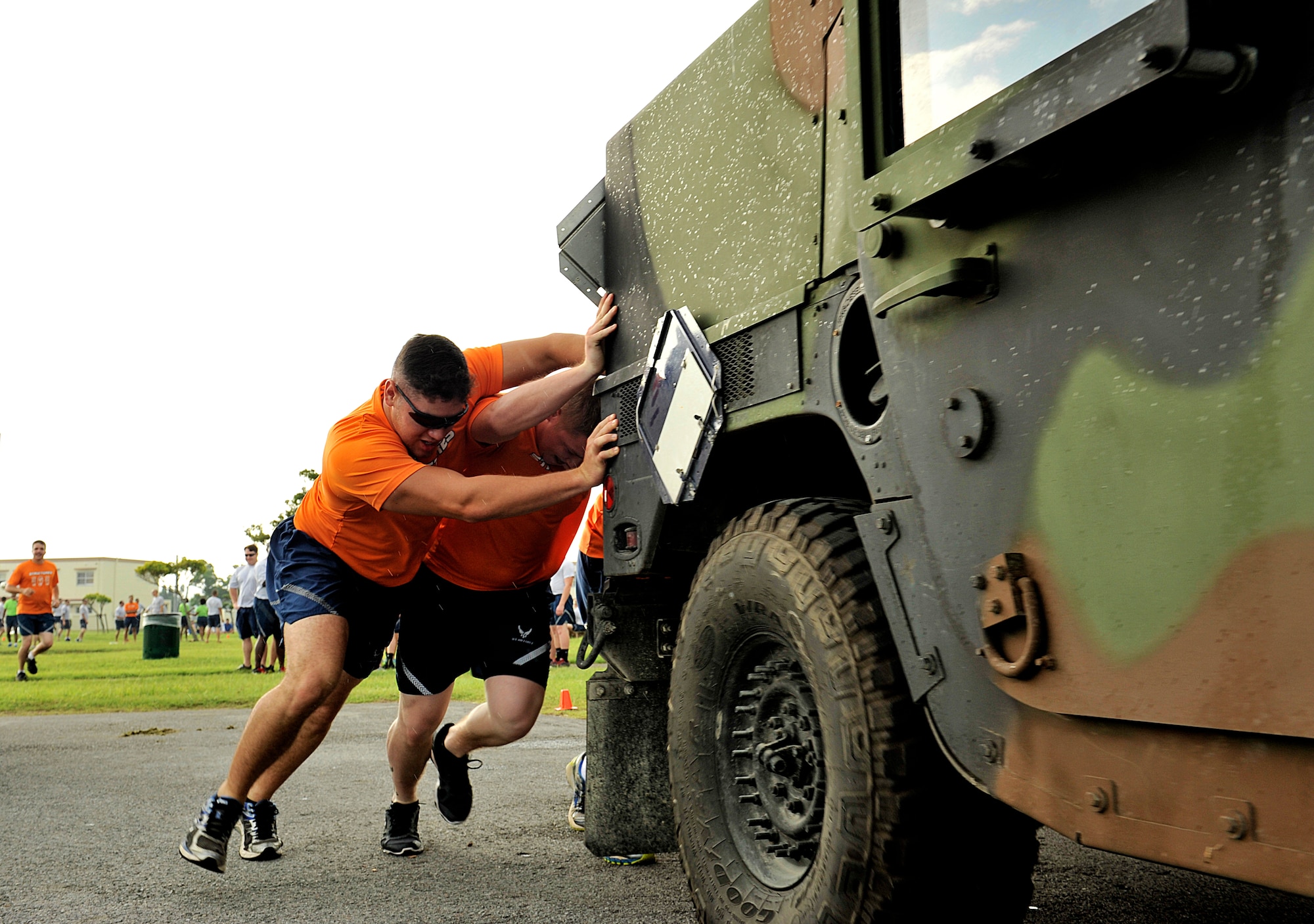 Airmen from the 18th Civil Engineer Group push a Humvee during a Wingman Day relay at Kenny Park Oct. 2, 2015, on Kadena Air Base, Japan. Wingman Day was an opportunity for Airmen to step outside of their day-to-day work environment to focus on team-building exercises as part of the Comprehensive Airmen Fitness Program. (U.S. Air Force photo by Naoto Anazawa)