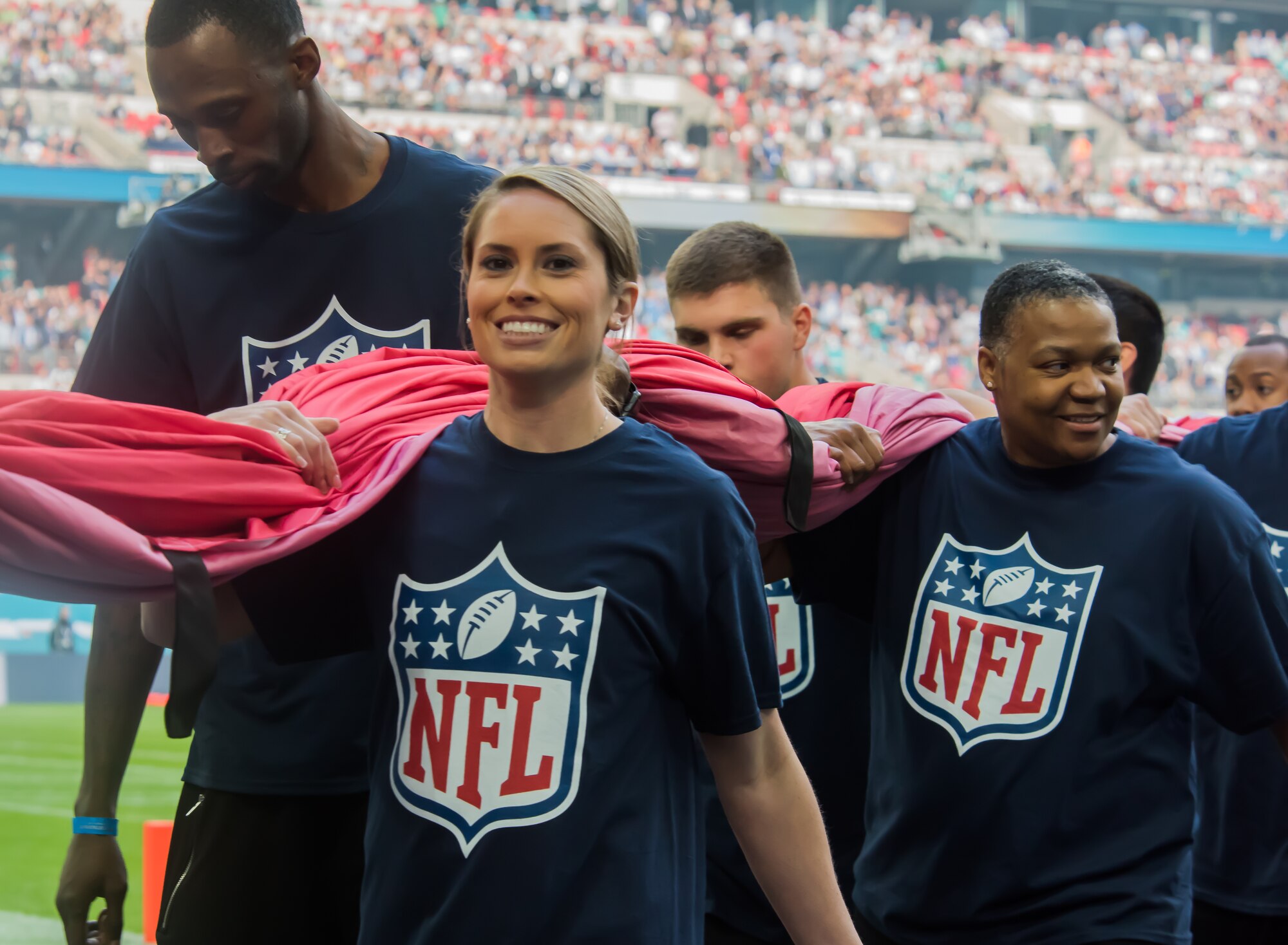 Airmen from Royal Air Force Lakenheath, England, walk back after performing a pre-game ceremony before the Miami Dolphins –New York Jets football game in London on Oct. 4, 2015. The game was the first of three international NFL games that will be played this season at Wembley Stadium. As part of the pregame ceremony, the 48 Fighter Wing Airmen presented U.S. and U.K. flags as a sign of the continued cooperation between U.S. visiting forces and their U.K. hosts. (U.S. Air Force photo/Senior Airman Trevor T. McBride/Released)