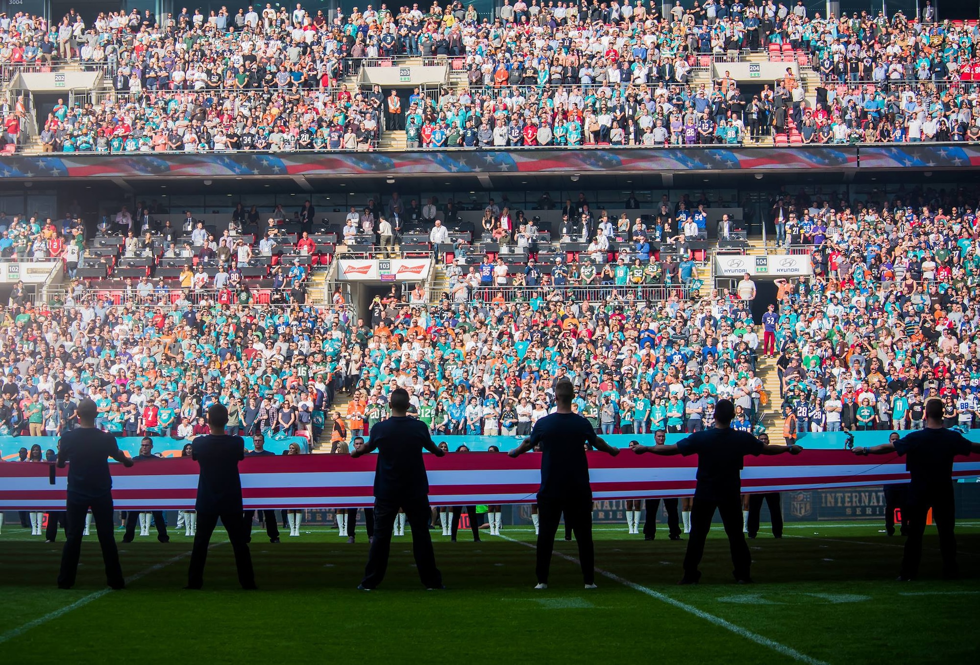 Airmen from Royal Air Force Lakenheath, England, walk back after performing a pre-game ceremony before the Miami Dolphins –New York Jets football game in London on Oct. 4, 2015. The game was the first of three international NFL games that will be played this season at Wembley Stadium. As part of the pregame ceremony, the 48th Fighter Wing Airmen presented U.S. and U.K. flags as a sign of the continued cooperation between U.S. visiting forces and their U.K. hosts. (U.S. Air Force photo/Senior Airman Trevor T. McBride/Released)