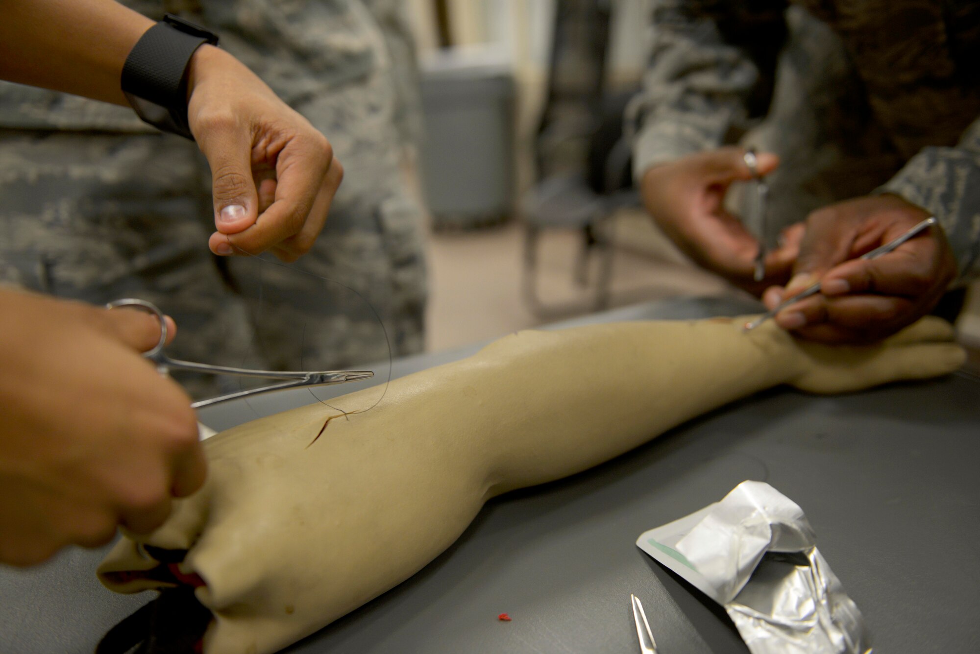 Airmen from the 39th Medical Operations Squadron practice suturing techniques during a training session Sept. 30, 2015, at Incirlik Air Base, Turkey. The training was one facet of a 4-hour reorientation and competency training where the Airmen trained on various job related skills. (U.S. Air Force photo by Senior Airman Krystal Ardrey)