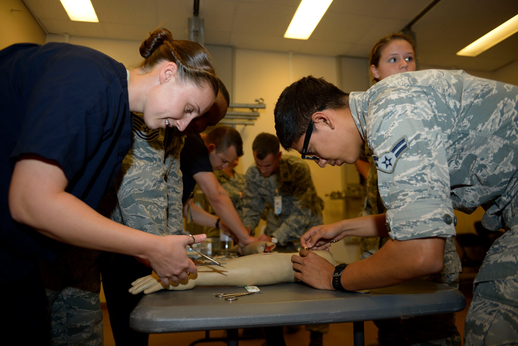 Staff Sgt. Brianna Lozano, 39th Medical Operations Squadron orthopedic technician, and Airman 1st Class Jesse Recarte, 39th MDOS pediatric medical technician, practice various suture techniques during a training session Sept. 30, 2015, at Incirlik Air Base, Turkey. Airmen from the 39th Medical Group attended 4-hours of training to train on multiple work-center specific competencies. (U.S. Air Force photo by Senior Airman Krystal Ardrey)
