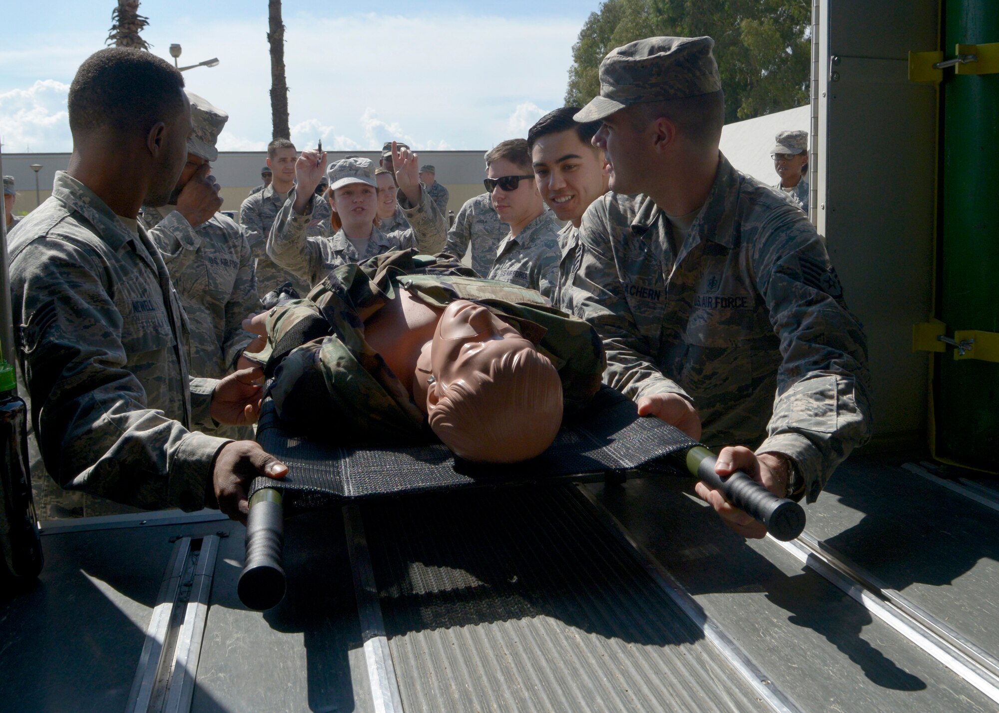 Airmen from the 39th Medical Group train on the proper way to load a medical litter into an ambulance during a training session Sept. 30, 2015, at Incirlik Air Base, Turkey. During a 4-hour reorientation and competency training, MDG Airmen learned how to how to carry litters, properly strap a patient onto a litter and load a litter into an ambulance bus. (U.S. Air Force photo by Senior Airman Krystal Ardrey)