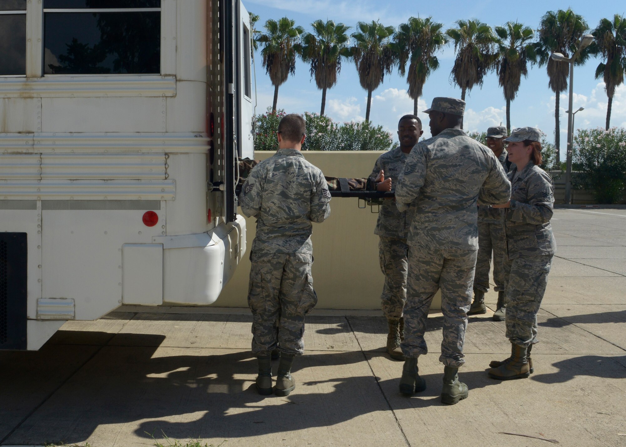 Airmen from the 39th Medical Group train on how to remove a litter from an ambulance bus Sept. 30, 2015, at Incirlik Air Base, Turkey. The training was held as part of a training day designed to orient new members on the procedures of the 39th MDG and verify skill competency. (U.S. Air Force photo by Senior Airman Krystal Ardrey)