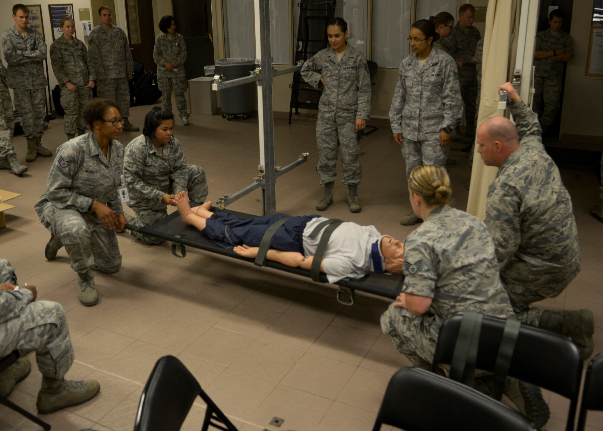 Airmen from the 39th Medical Group train on how to safely stack medical litters onto stanchions Sept. 30, 2015, at Incirlik Air Base, Turkey. The training was one facet of a 4- hour reorientation and competency training where the Airmen learned how to carry medical litters, properly strap a patient onto a litter and load a litter into an ambulance bus. (U.S. Air Force photo by Senior Airman Krystal Ardrey)