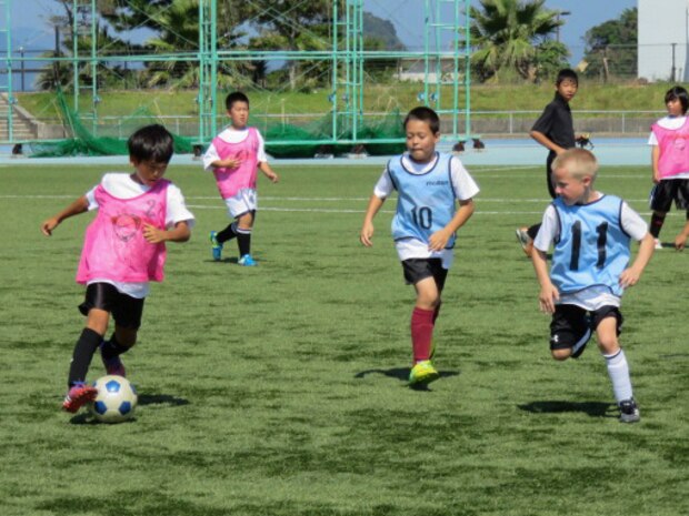 Japanese children from schools in the local area and children from Marine Corps Air Station, Iwakuni, Japan, participate in the Japan-U.S. Friendship Kid's Soccer Event coordinated by the Chugoku-Shikoku Defense Bureau at the Suo-Oshima Town Athletics Track and Field in Yamaguchi Prefecture, Japan, Sept. 27, 2015. This annual event serves as an opportunity for American and Japanese children to interact and help build bonds between the people of the U.S. and Japan.