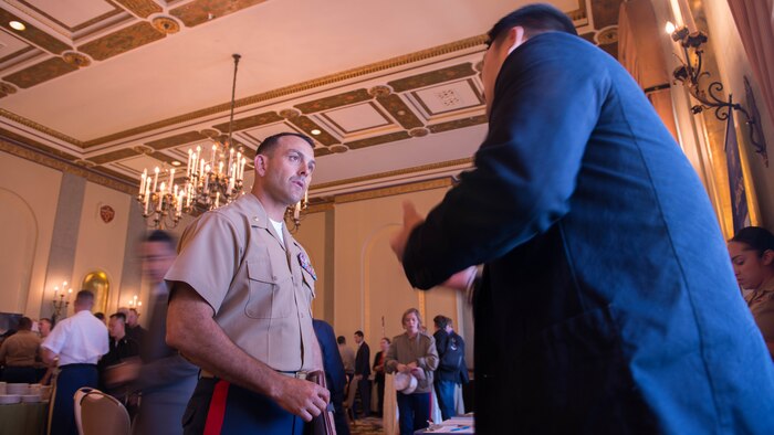 Maj. Asa Warrington talks to Jeff Park, a field associate of Iraq and Afghanistan Veterans of America, about the many opportunities available to the Marines after they leave the military during the Veteran Employment Summit at Marines' Memorial Club and Hotel Oct. 6, 2015 as Part of Fleet Week San Francisco 2015 in San Francisco. Military and civilian leaders provided service members with opportunities available to them after their active service.