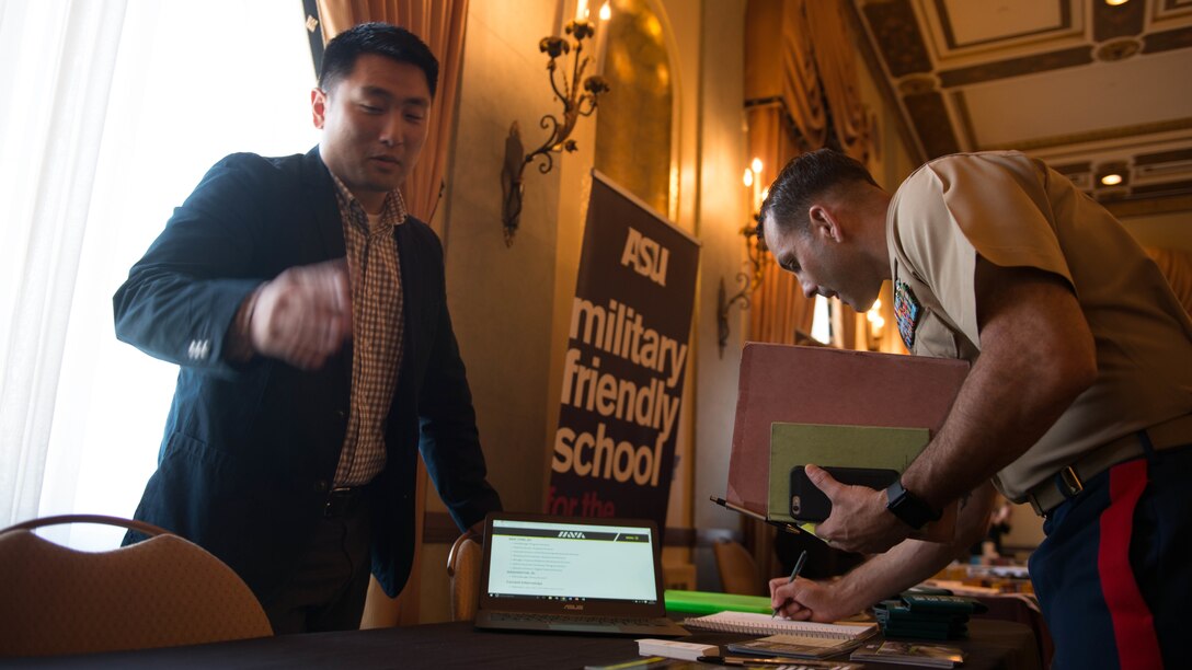 Maj. Asa Warrington talks to Jeff Park, a field associate of Iraq and Afghanistan Veterans of America, about the many opportunities available to Marines after their military service ends, during the Veteran Employment Summit at Marines' Memorial Club and Hotel Oct. 6, 2015 as Part of Fleet Week San Francisco 2015 in San Francisco. Representatives from Hewlett Packard, Survey Monkey and Arizona State University provided military members with different opportunities avaliable to them after the end of their active service.