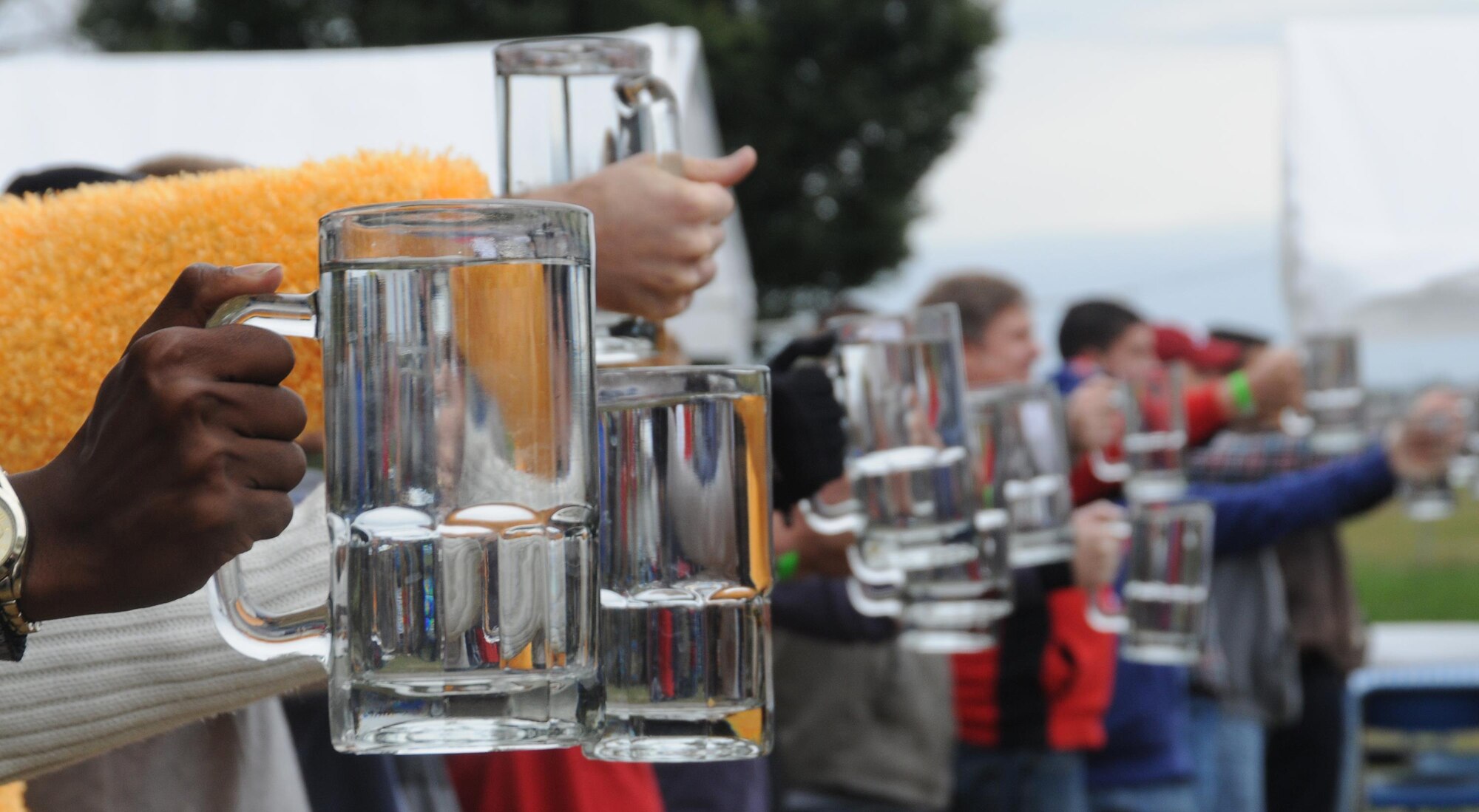 Employees of the National Air and Space Intelligence Agency, participate in a stein raise contest, during the center's 47th Annual Oktoberfest celebration at Bass Lake, Oct. 2, 2015. Employees participated in other events as well, such as a keg toss, log-saw and tug-of-war. (U.S. Air Force photo by Staff Sgt. Marianne E. Lane)