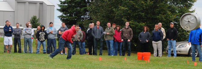 Capt. Joshua Loomis, National Air and Space Intelligence Center employee, competes in a keg toss contest during the center's 47th Annual Oktoberfest celebration at Bass Lake, Oct. 2, 2015. Employees participated in other events as well, such as a keg toss, log-saw and tug-of-war. (U.S. Air Force photo by Staff Sgt. Marianne E. Lane)