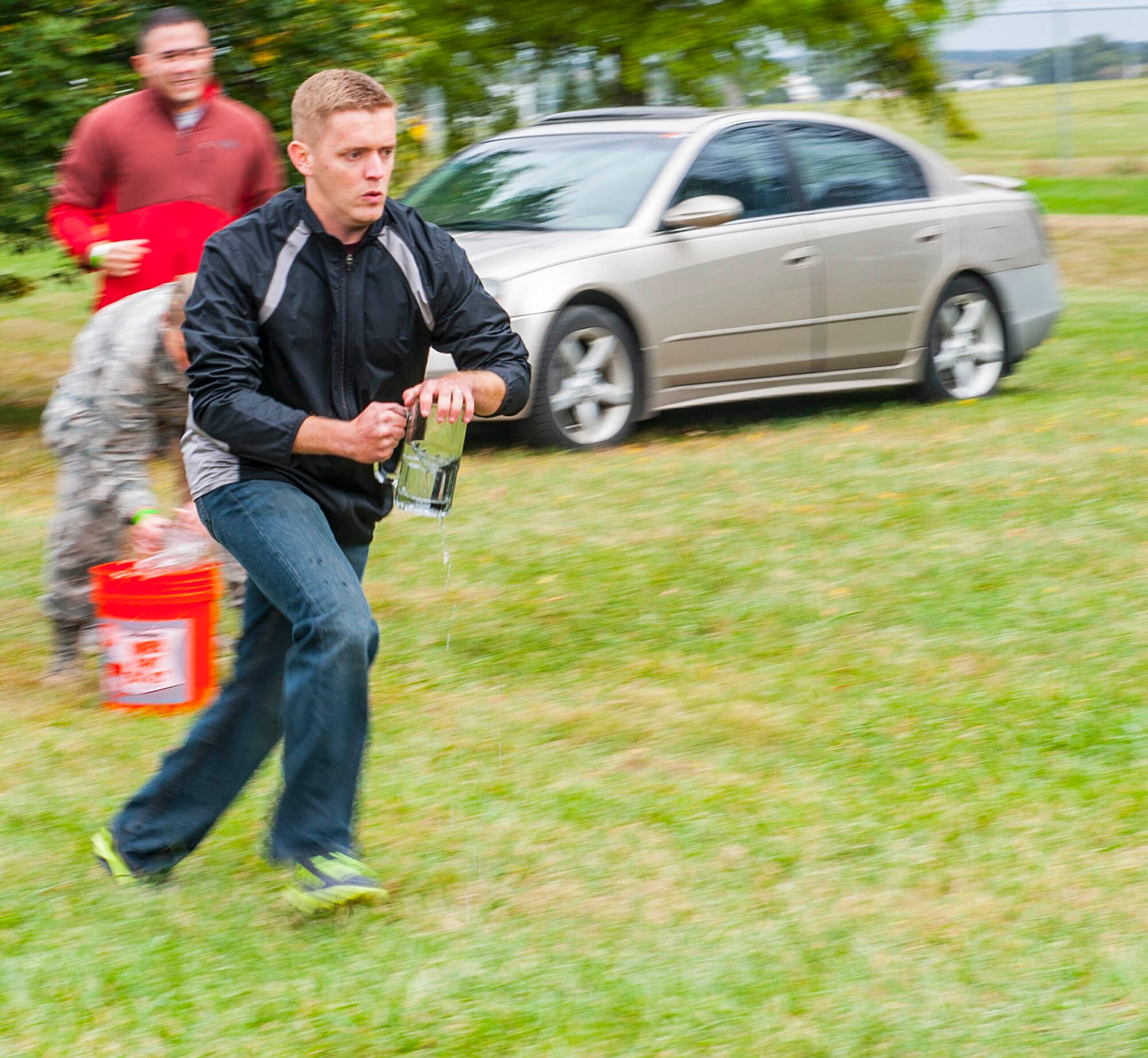 WRIGHT PATTERSON AIR FORCE BASE, Ohio -- Tech. Sgt. Daniel Bava, National Air and Space Intelligence Center, competes in the stein relay competition during the center's 47th Annual Oktoberfest celebration at Bass Lake, Oct. 6, 2015. During the celebration different units within the center compete in the Oktoberfest games while enjoying traditional German cuisine. (U.S. Air Force photo by Tech. Sgt. Eunique P. Thomas)