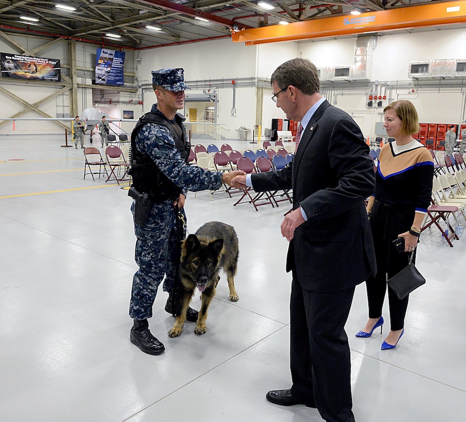 U.S. Defense Secretary Ash Carter gives a coin to a military dog handler at Naval Air Station Sigonella, Italy, Oct. 6, 2015. DoD photo by U.S. Army Sgt. 1st Class Clydell Kinchen