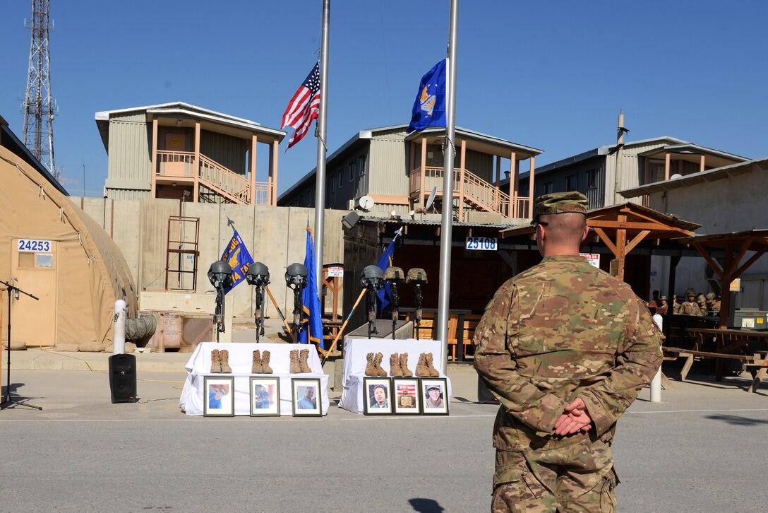 U.S. Air Force Maj. Met Berisha, 455th Expeditionary Security Forces Squadron commander, stands at parade rest during a memorial ceremony held in honor of six U.S. airmen on Bagram Airfield, Afghanistan, Oct. 3, 2015. The six airmen, four who were pilots and crew members, Capts. Jordan Pierson and Jonathan Golden, Staff Sgt. Ryan Hammond and Senior Airman Quinn Johnson-Harris, and two who were security forces fly-away security team members, Senior Airman Nathan Sartain and Airman 1st Class Kcey Ruiz, lost their lives when their C-130J aircraft crashed shortly after takeoff from Jalalabad Airfield, Afghanistan, Oct. 2, 2015. U.S. Air Force photo by Senior Airman Cierra Presentado