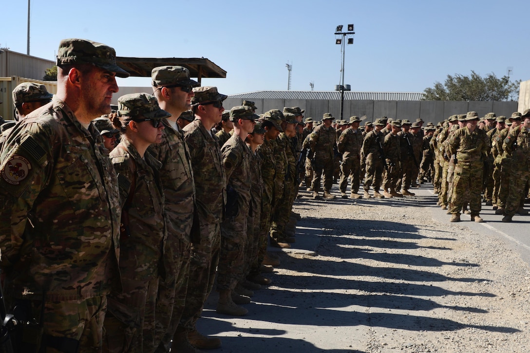 U.S. airmen gather to pay respect and mourn the loss of six fellow airmen during a memorial ceremony on Bagram Airfield, Afghanistan, Oct. 3, 2015. U.S. Air Force photo by Senior Airman Cierra Presentado