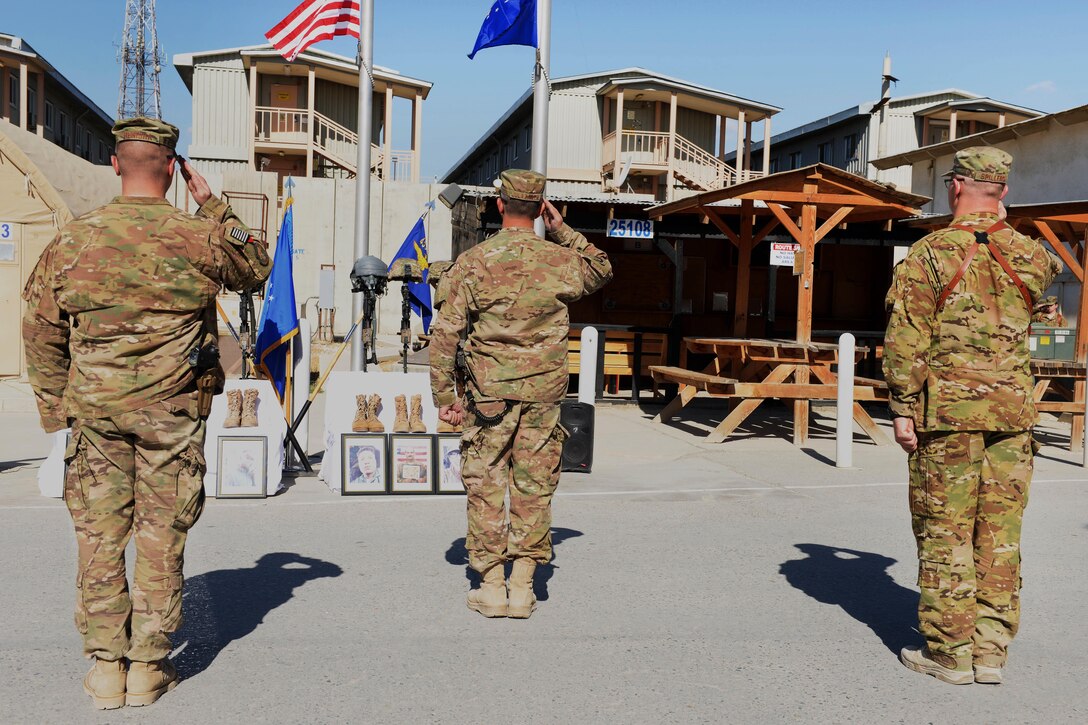 U.S. Air Force Brig. Gen. David Julazadeh, 455th Air Expeditionary Wing commander, center, U.S. Air Force Maj. Met Berisha, left, and U.S. Air Force Lt. Col. Mitchell Spillers, right, salute the memorial of six fallen U.S. airmen during a ceremony on Bagram Airfield, Afghanistan, Oct. 3, 2015. Spillers is commander of the 774th Expeditionary Airlift Squadron and Berisha is commander of the 455th Expeditionary Security Forces Squadron. U.S. Air Force photo by Senior Airman Cierra Presentado