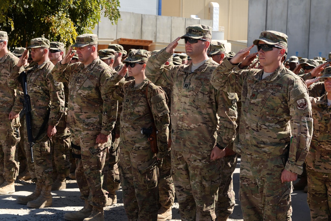 U.S. airmen salute the memorial of six fallen airmen during a ceremony on Bagram Airfield, Afghanistan, Oct. 3, 2015. U.S. Air Force photo by Senior Airman Cierra Presentado