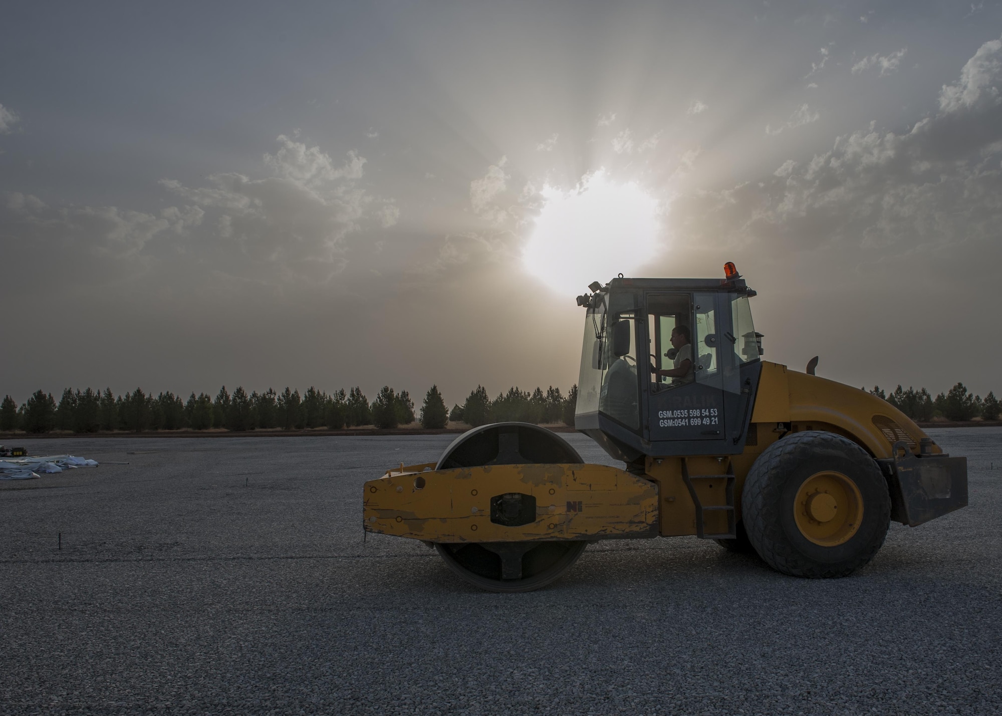 Staff Sgt. Adam Borjon, a 435th Construction Training Squadron engineer system’s operator, rolls gravel Sept. 13, 2015, at Diyarbakir Air Base, Turkey. The 435th CTS falls under the 435th Contingency Response Group at Ramstein Air Base, Germany. The group is deployed in support of the U.S. Air Force staging of aircraft and Airmen at Diyarbakir AB in southeast Turkey to enhance coalition capabilities to support personnel recovery operations in Syria and Iraq. (U.S. Air Force photo/Airman Cory W. Bush)