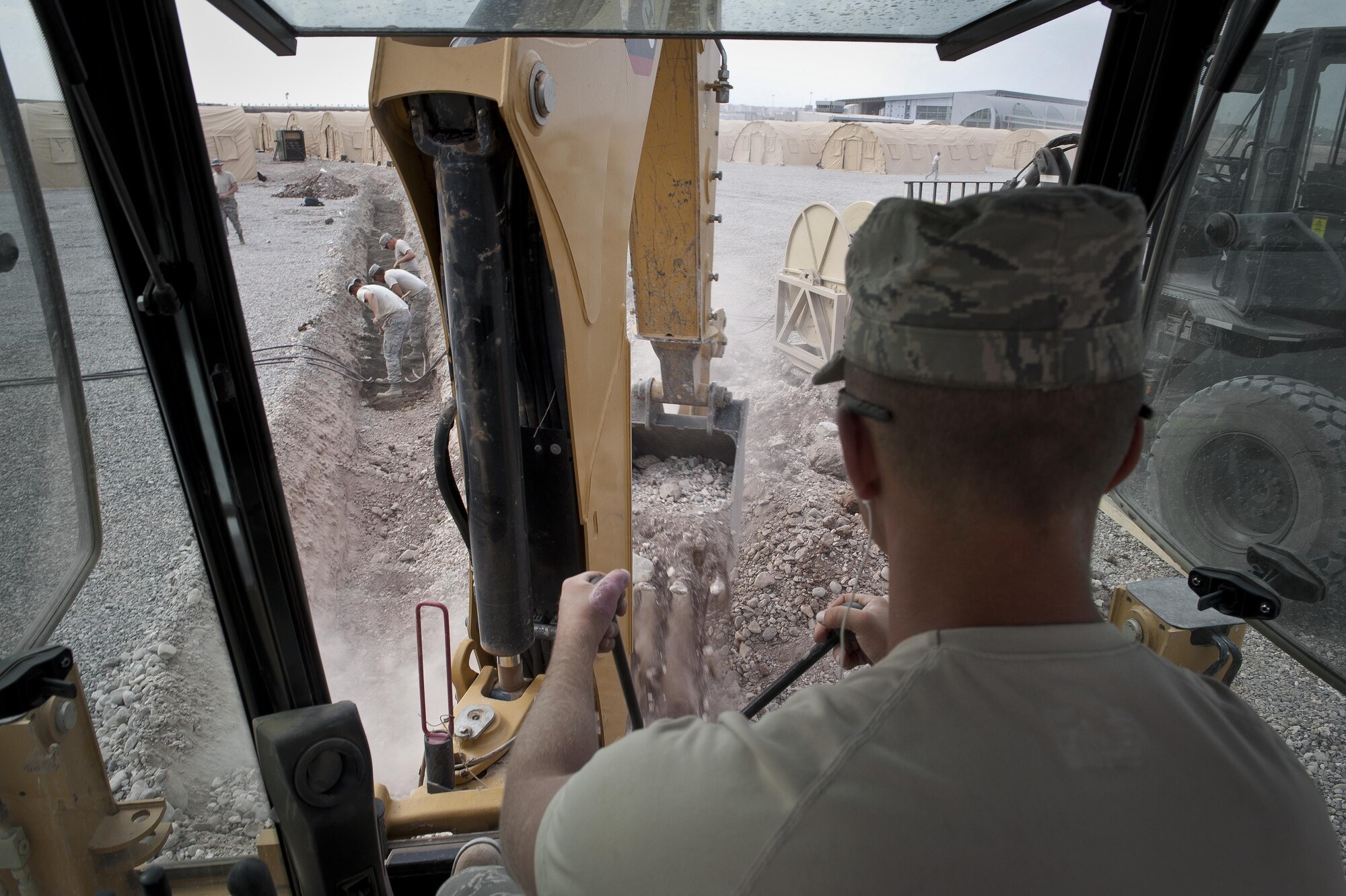 Staff Sgt. Logan Pals, a 435th Construction Training Squadron military construction flight pavement and equipment operator, digs a trench Sept. 22, 2015, in preparation for personnel recovery operations at Diyarbakir Air Base, Turkey. The 435th CTS falls under the 435th Contingency Response Group at Ramstein Air Base, Germany. The group provides a cross-functional, rapidly deployable airborne force designed to assess and open air bases and perform initial airfield operations enabling rapid standup of combat operations anywhere in the U.S. European Command and U.S. Africa Command’s area of responsibilities. (U.S. Air Force photo/Airman Cory W. Bush)