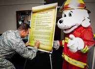 Col. Sean Farrell, 1st Special Operations Wing commander, signs this year’s Fire Prevention Week Proclamation on Hurlburt Field, Fla., Oct. 1, 2015. Fire Prevention Week events will be held Oct. 4-8, to help create a safe environment where Airmen and their families can thrive. (U.S. Air Force photo by Senior Airman Meagan Schutter)