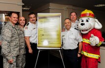Col. Sean Farrell, 1st Special Operations Wing commander, stands with 1st Special Operations Civil Engineer Squadron fire chiefs and Sparky the fire dog after signing this year’s Fire Prevention Week Proclamation on Hurlburt Field, Fla., Oct. 1, 2015. Fire Prevention Week events will be held Oct. 4-8, to help create a safe environment where Airmen and their families can thrive. (U.S. Air Force photo by Senior Airman Meagan Schutter)