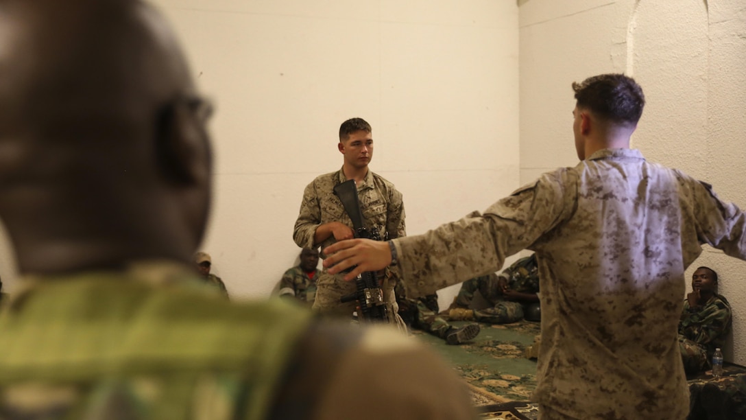Marines with 1st Battalion, 8th Marine Regiment lead a class on how to properly search someone to role players acting as an African army at the Infantry Immersion Training Center at Marine Corps Base Camp Lejeune, N.C., Sept. 30, 2015.  The training is designed to better prepare them for their upcoming deployment with Special Purpose Marine Air-Ground Task Force-Logistical Command Element Africa.  (U.S. Marine Corps Photo by Cpl. Michael Dye/Released) 